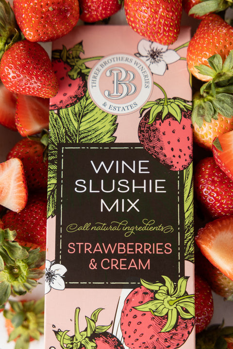 a box of three brothers wineries strawberries and cream wine slushie mix surrounded by fresh strawberries